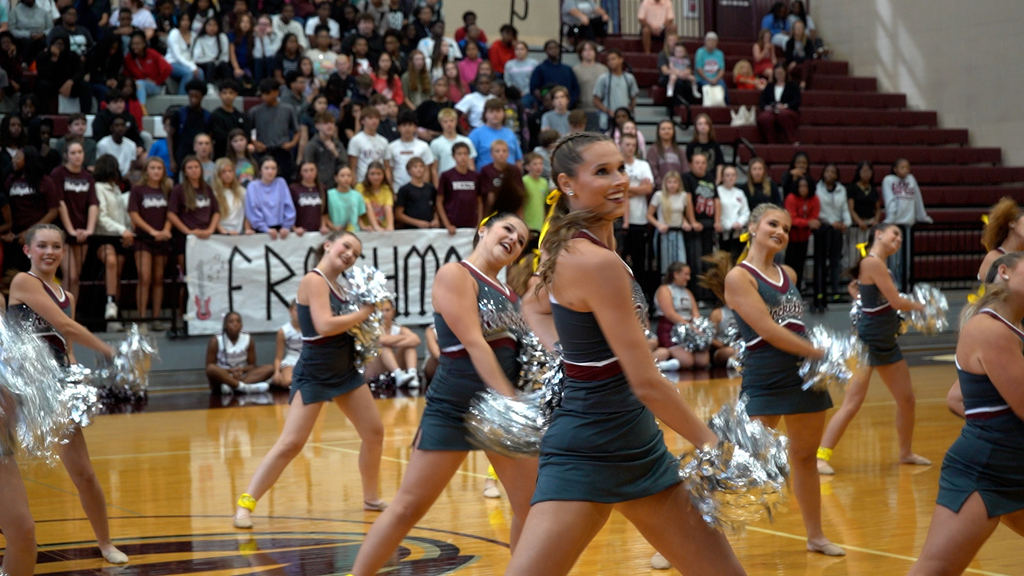 A dance team performs at a pep rally