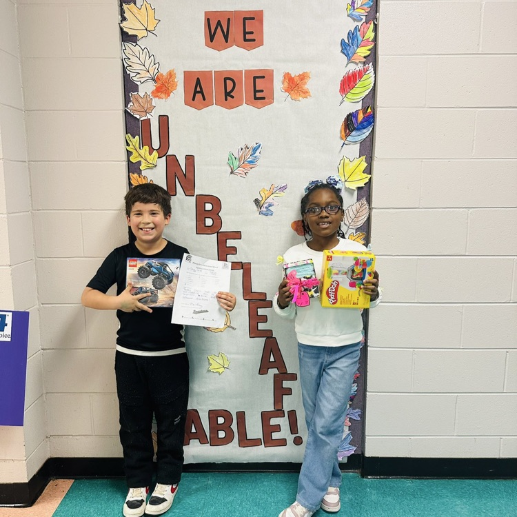 Two students are holding a certificate for a Positive Office Referral.