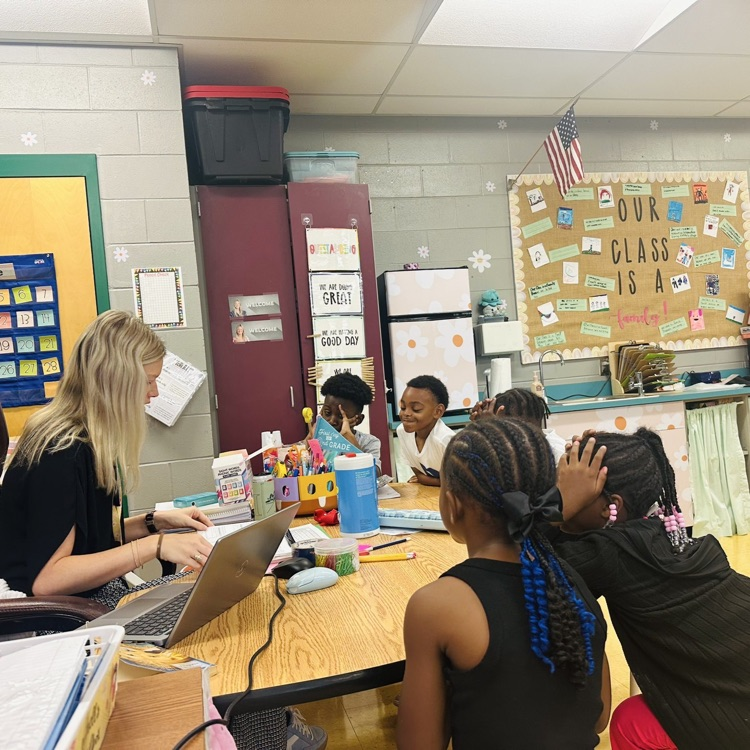 Students working with Ms. Mitchell in a Phonics First small group.