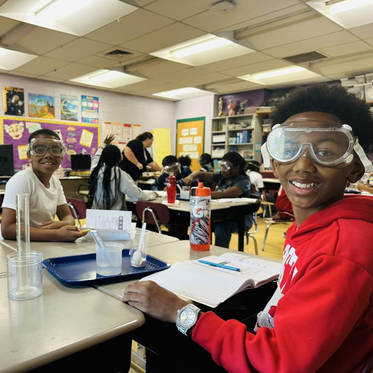 Students wearing safety glasses to do a Science experiment.