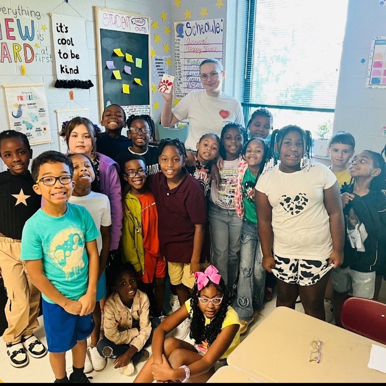 Ms. McBride's class is posing as the "Song of the Week" winning class.