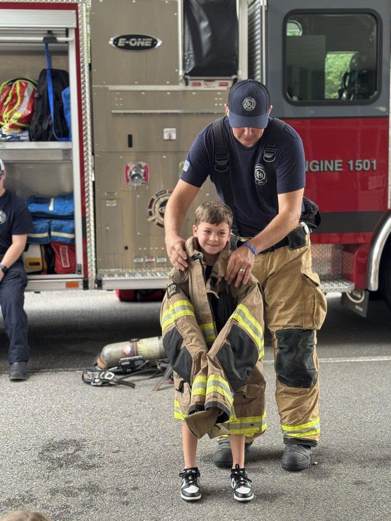 Student trying on fireman's jacket