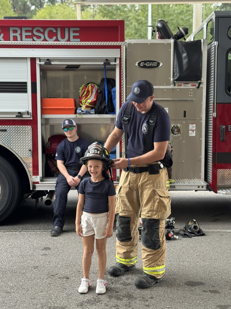 Student trying on fireman's helment