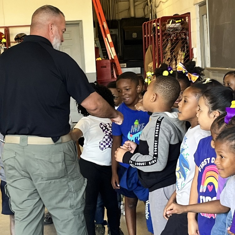 Students talking with a fire fighter.