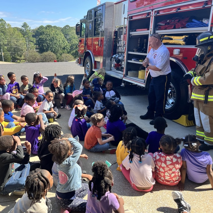 Students listening to the Fire Chief talk about the fire truck.