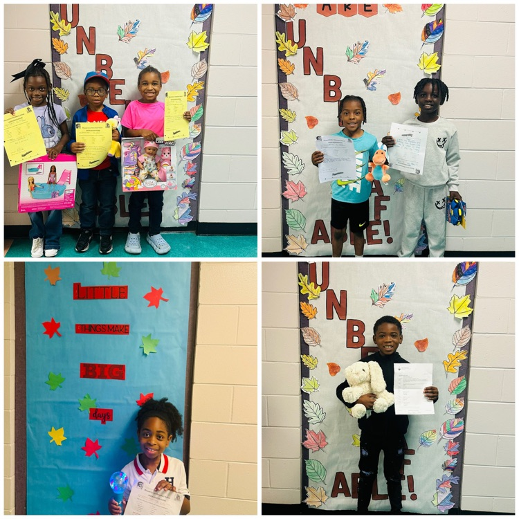 Students posing with their prize for earning a Positive Office Referral.
