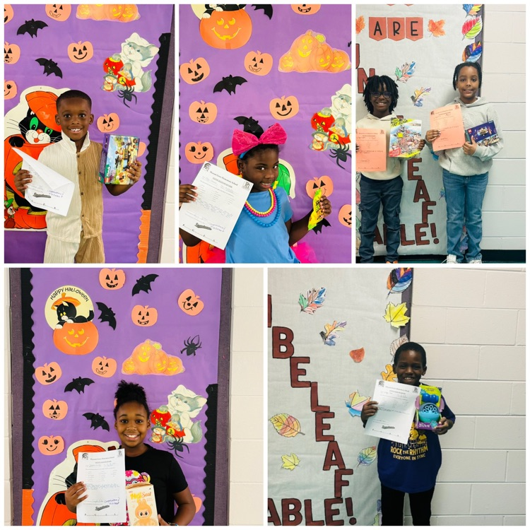 Students posing with their prize for earning a Positive Office Referral.