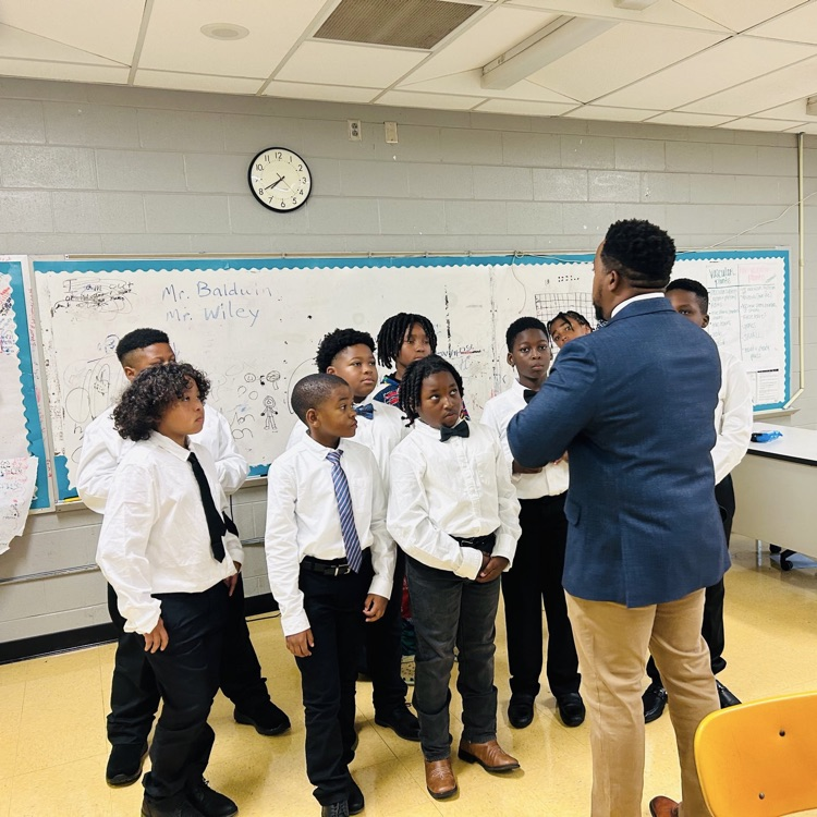 A picture of the Kappa Kids listening to a speaker.