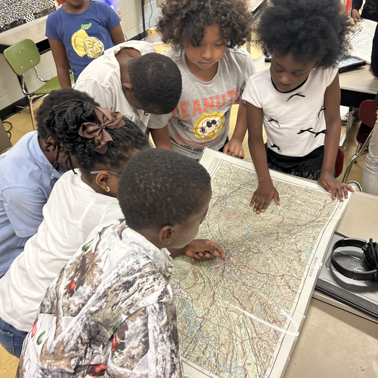 Students looking at a map.