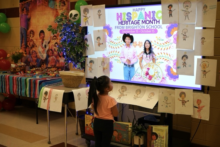 A child looks at Hispanic Heritage display at a school.