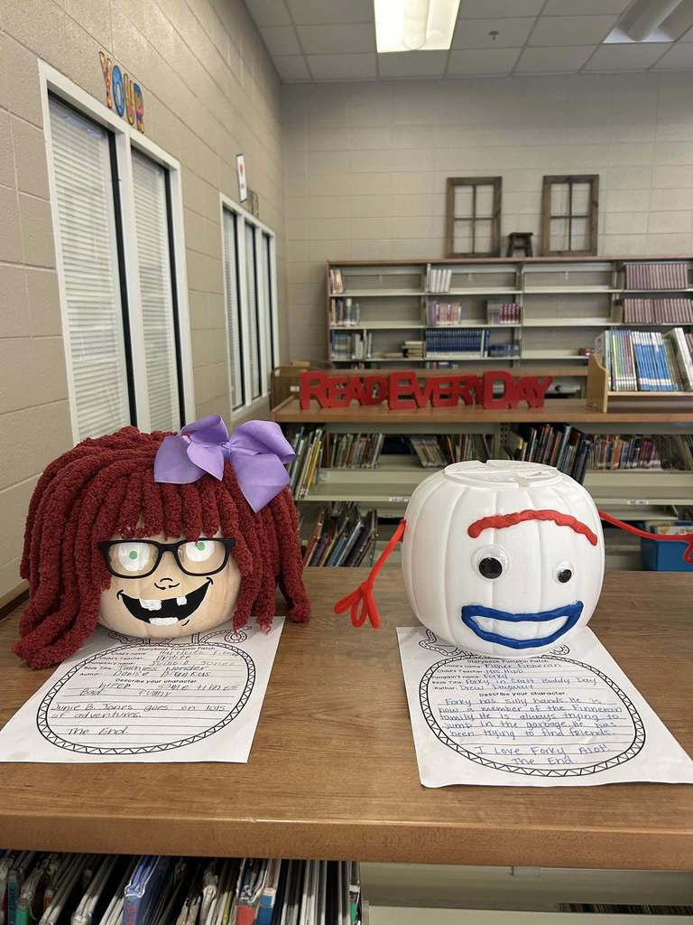 Pumpkins decorated like book characters sit on the shelves of a library.