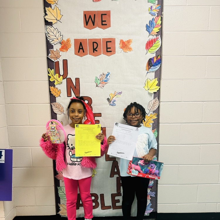 Two students posing for a picture because they earned a Positive Office Referral.