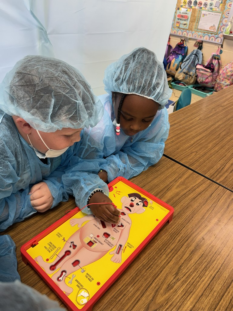 Students dressed as surgeons playing Operation