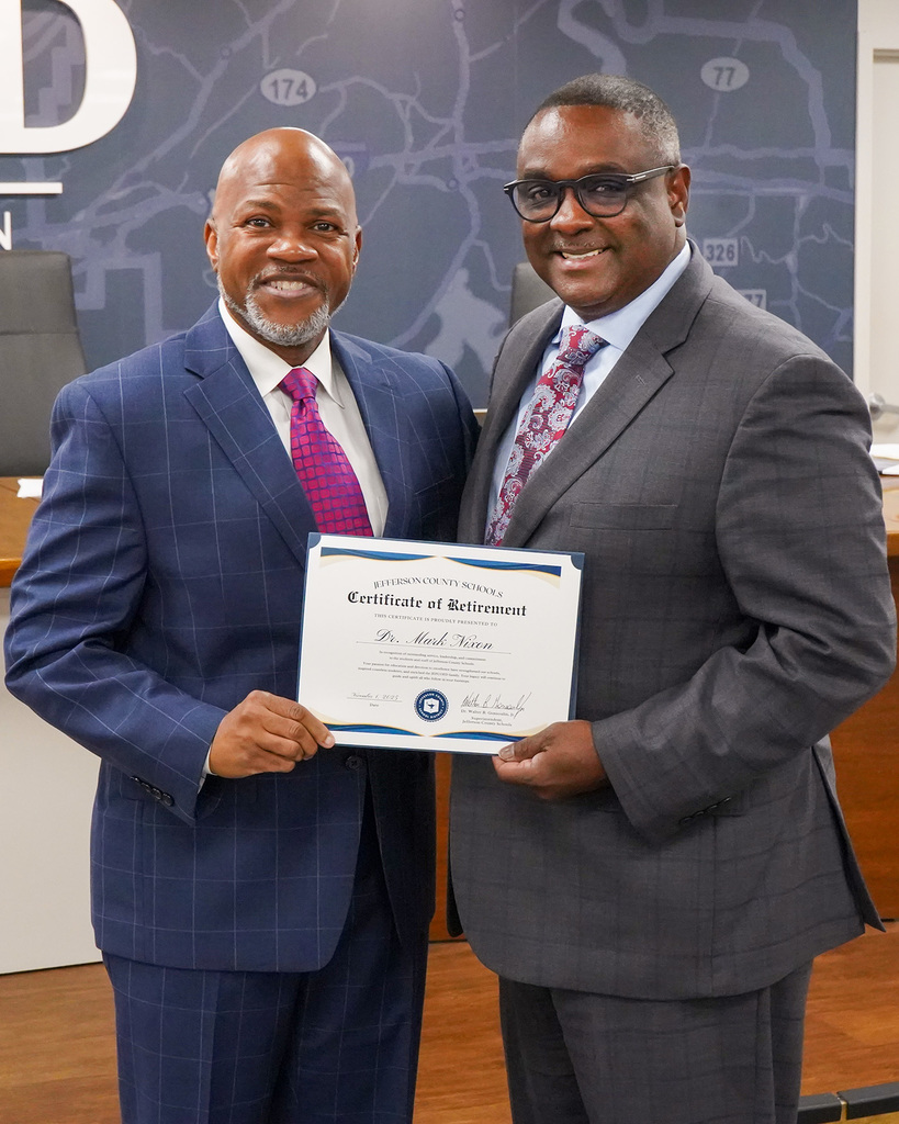 Retired Minor Community School Principal Dr. Mark Nixon stands for a photo with JEFCOED Superintendent Dr. Walter Gonsoulin. They hold a certificate congratulating Dr. Nixon on his retirement.