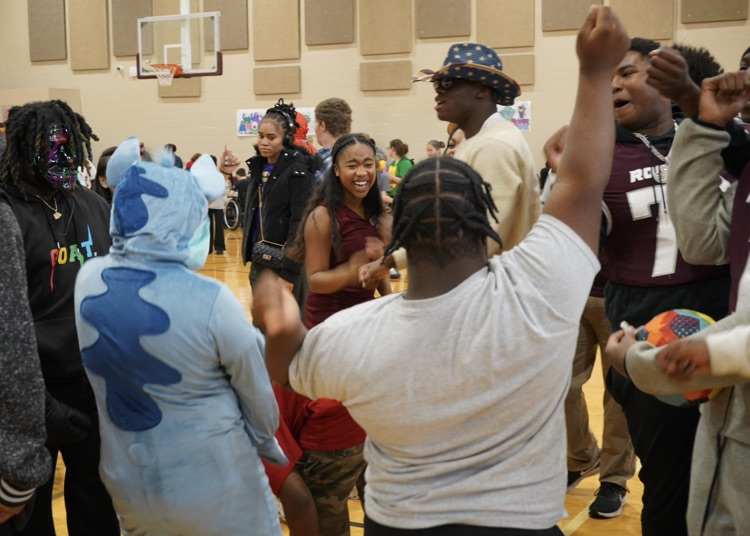 Students dance together in a school gym  