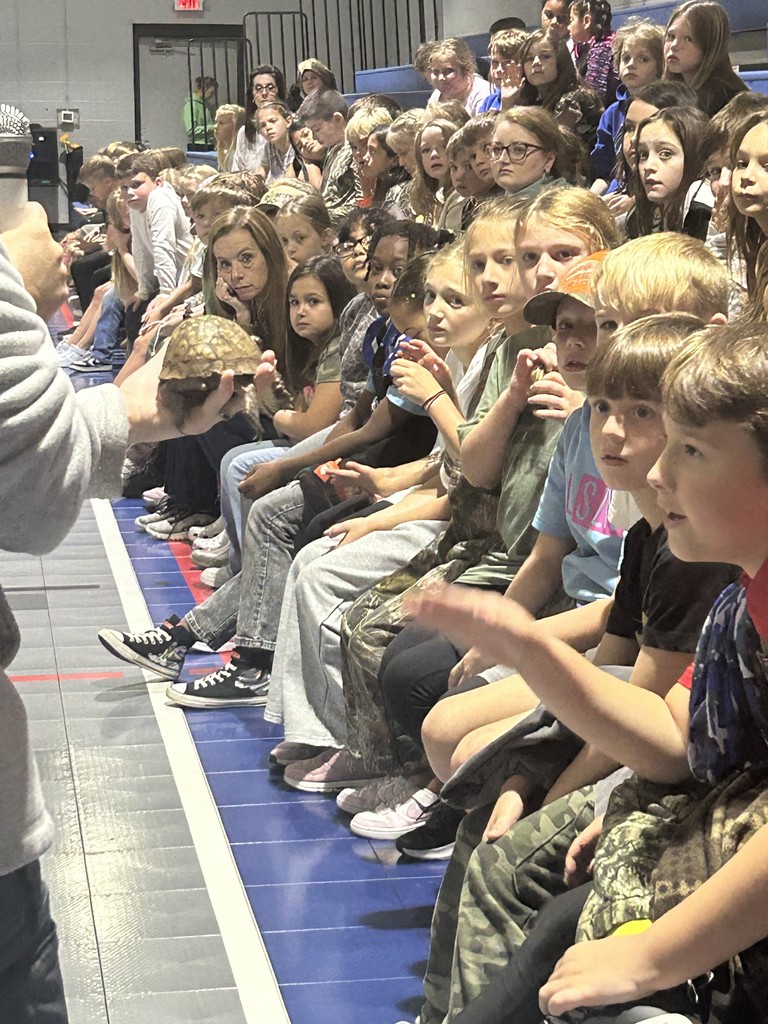 Emily Hutto from Jefferson County Greenway showing students a turtle