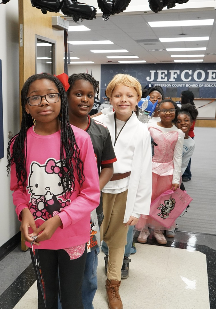 Students stand in a hallway and smile