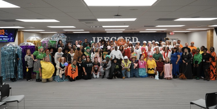 JEFCOED board employees wear Halloween costumes and stand together for a photo.