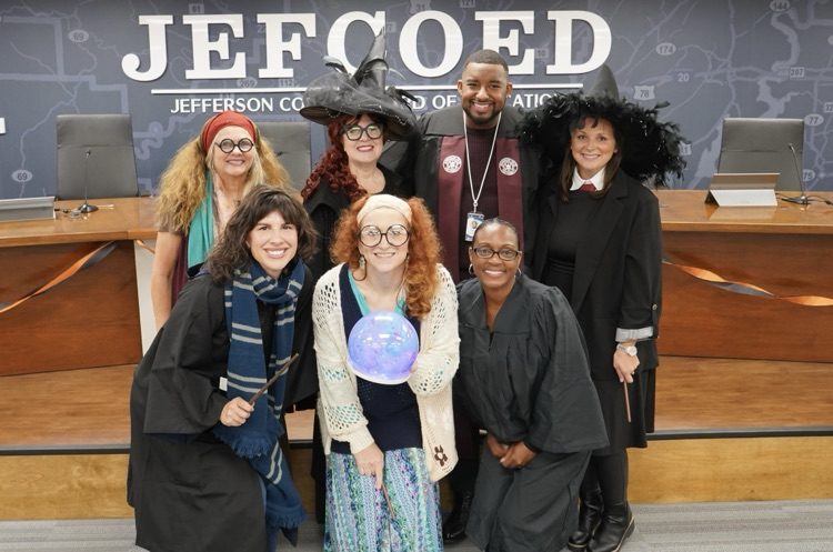 A group of JEFCOED board employees stand together for a photo. They are dressed in Harry Potter themed costumes.