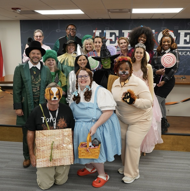 JEFCOED board employees dressed as characters from the Wizard of Oz stand together and smile.