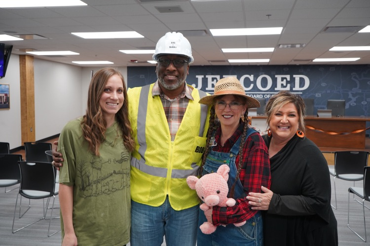 JEFCOED employees wearing costumes stand together and smile  