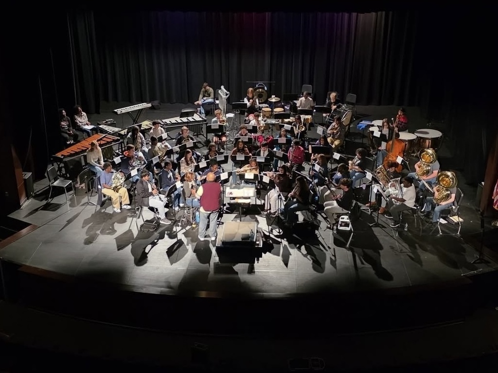 JEFCOED All County Band members rehearse on a stage. 