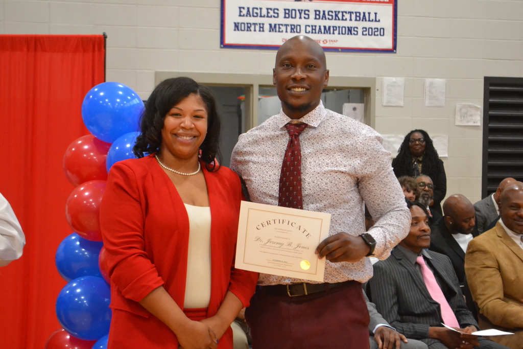 Mrs. Lillie  giving Dr. Jones a certificate of appreciation