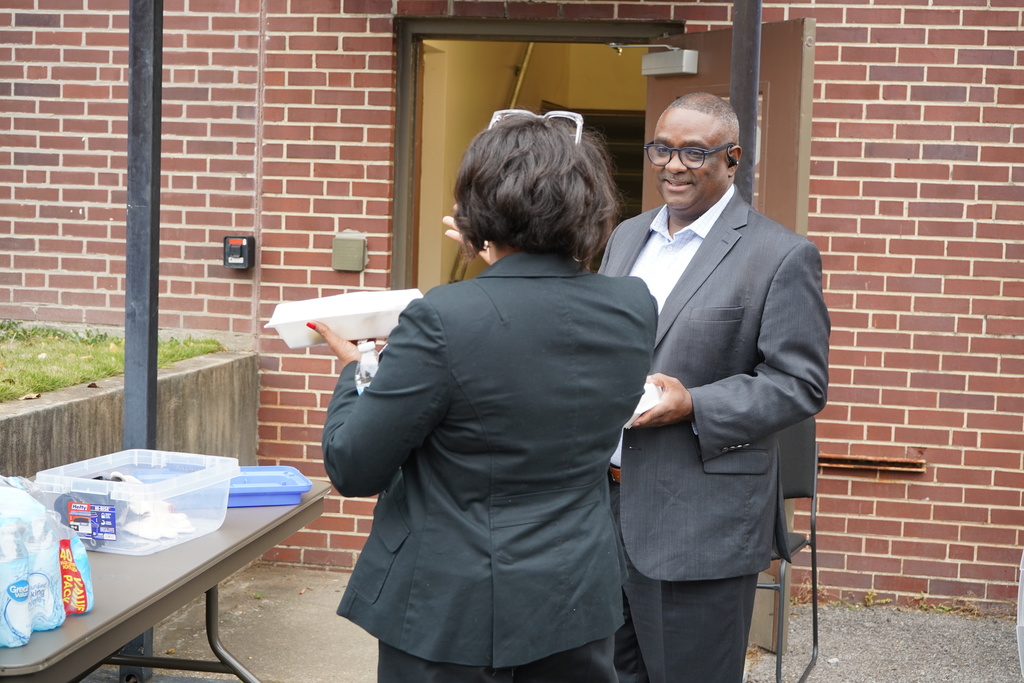 JEFCOED Superintendent Dr. Walter Gonsoulin smiles whille talking to a JEFCOED Employee outside the Central Office Building.