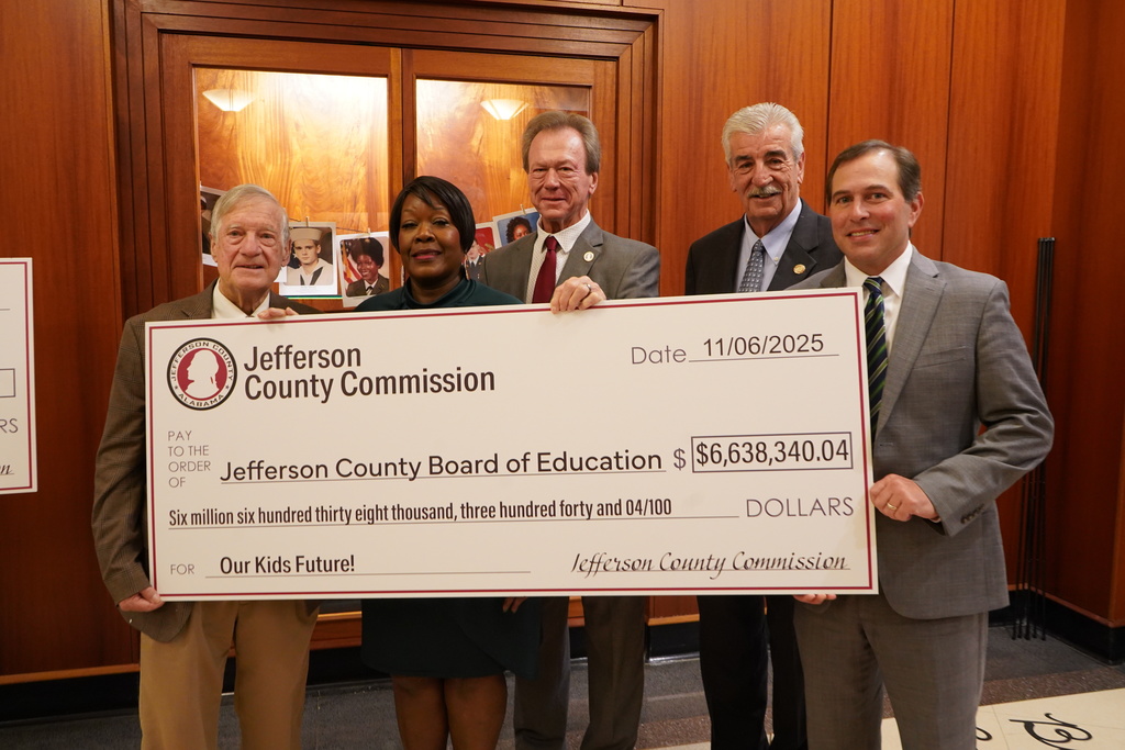 Jimmie Stephens, Sheila Tyson, Mike Bolin, Joe Knight and Jeff Caufield smile for a photo while holding a check from the Jefferson County Commission for $6,638,340.04.