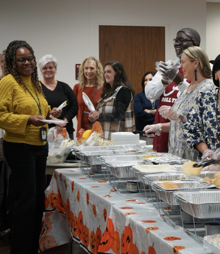 JEFCOED employees smile as they stand in line for Thanksgiving lunch.