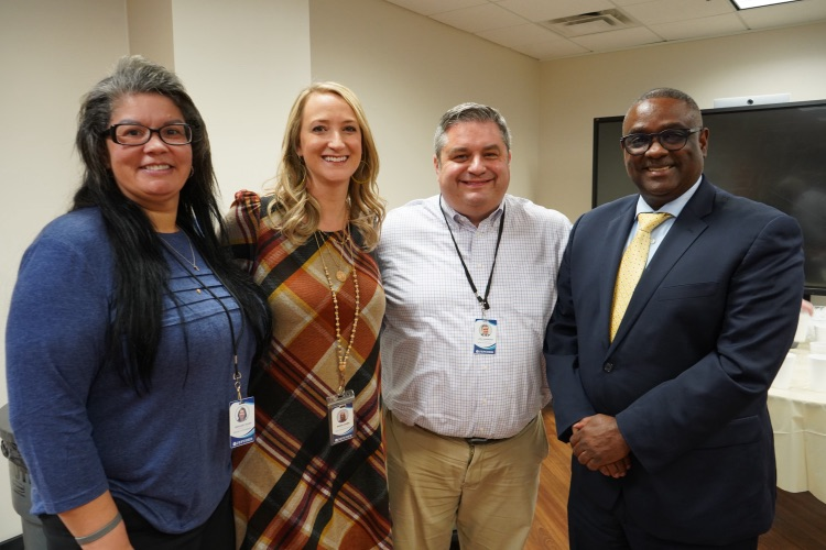 JEFCOED employees and Superintendent Dr. Gonsoulin stand together and smile for a photo.