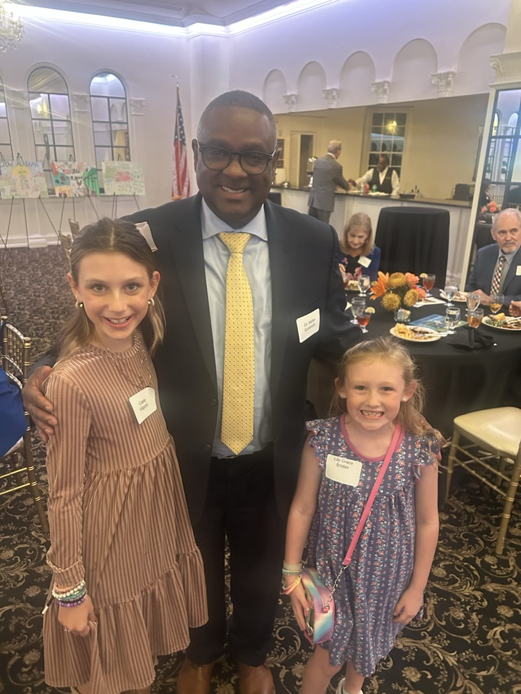 JEFCOED Superintendent Dr. Gonsoulin smiles and stands next to two students for a photo.