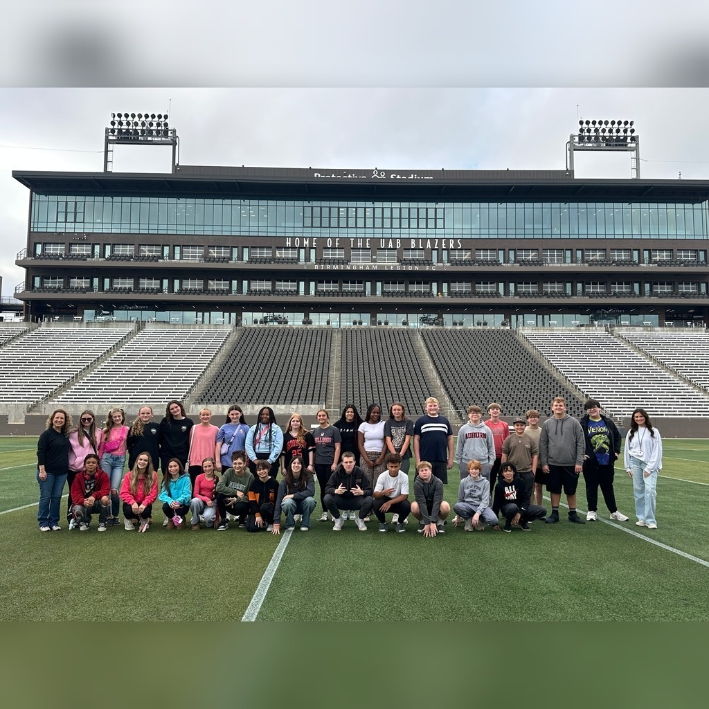 North Jefferson Middle School's FBLA students and educators stand together for a photo on the field at Protective Stadium.