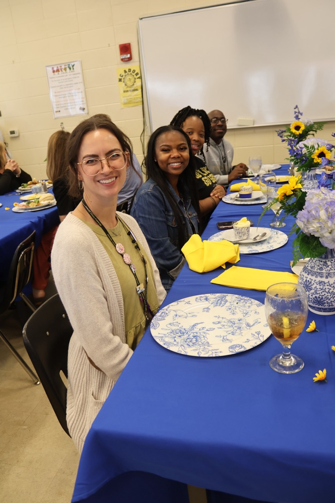 McAdory High School faculty sit at a table and smile.