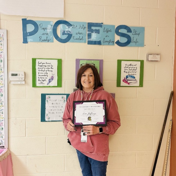A picture of Mrs. Jeffreys holding her certificate for being the November Employee of the month.