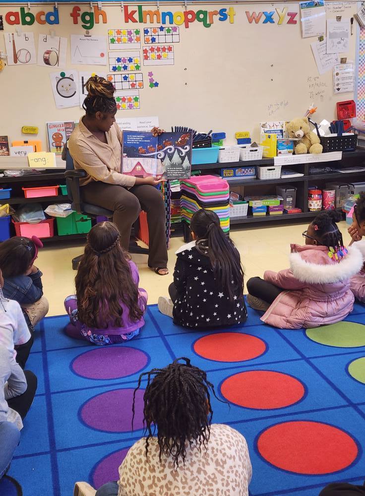 A Center Point High School student reads to Center Point Elementary students.