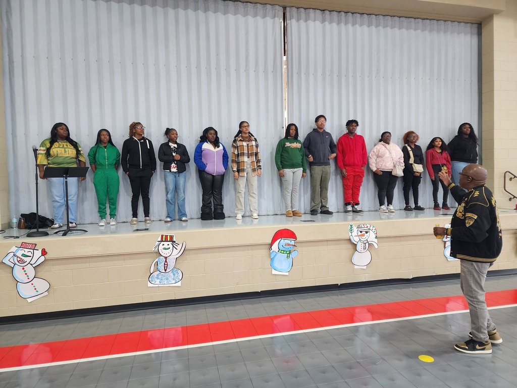Center Point High School students sing on a stage inside a school.