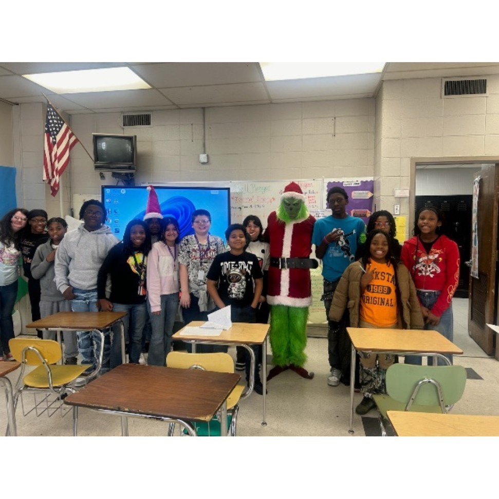 The Grinch visiting with students 