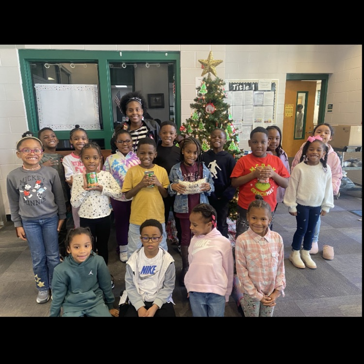 Ms. Robinson's class posing with food items on the picture.
