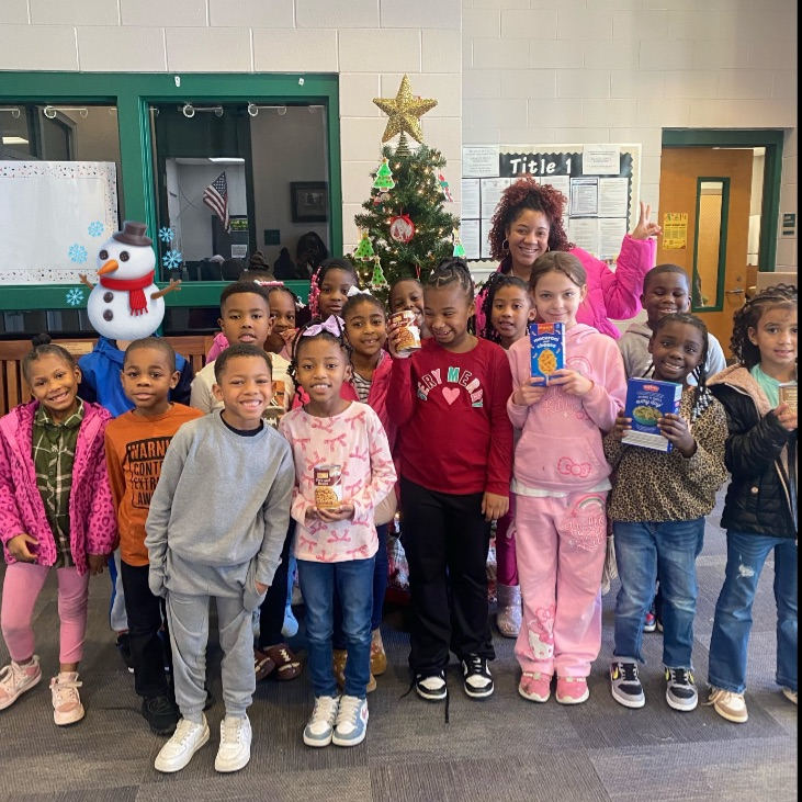 Ms. Ford's class posing with food for the picture.
