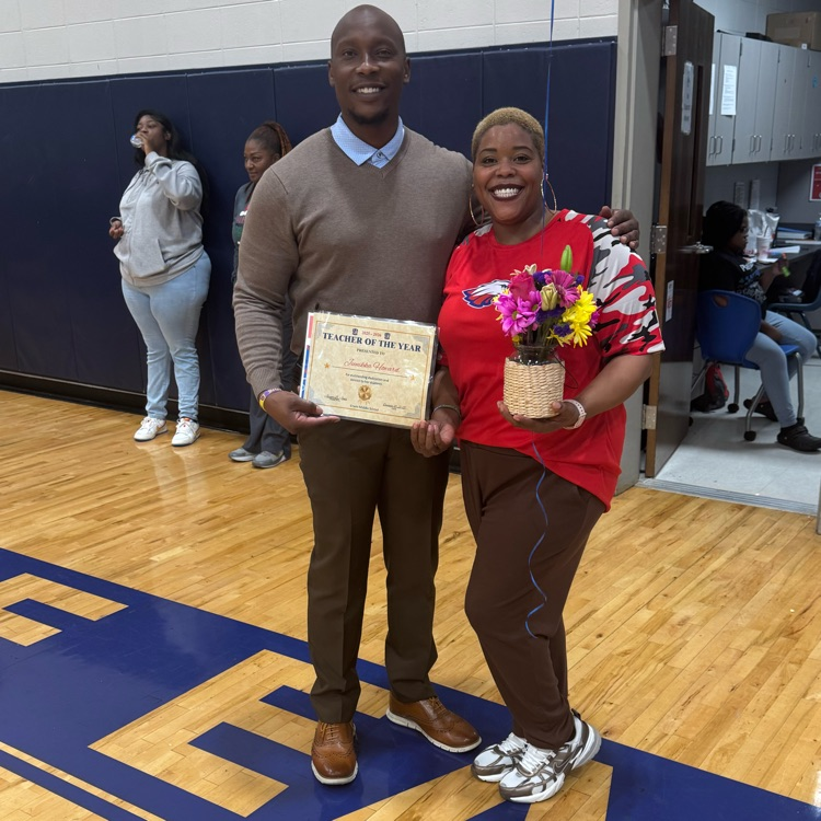 dr. Jones awarding Mrs.Howard teacher of the year award at the end of the student teacher volleyball game