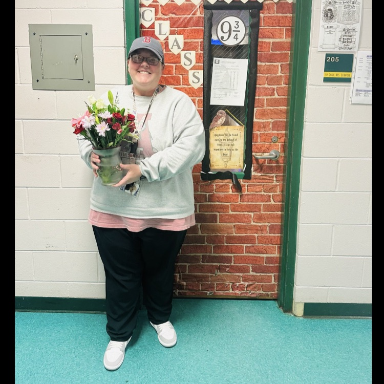 Ms. Hayes holding flowers she was given for being selected the Teacher of the Year for PGES.