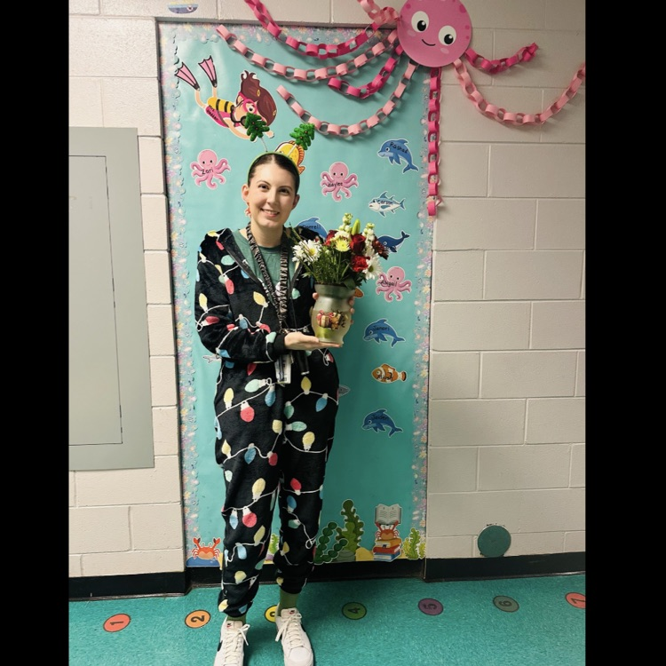 Mrs. Hadden holding a certificate for being chosen as the JEFCOED Strong Award teacher at PGES this quarter.