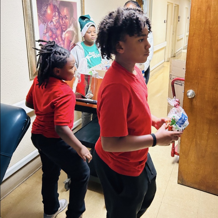 Kappa Kids handing out toiletries to patients at Legacy Rehab rehabilitation Center.