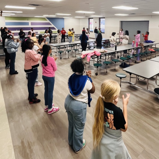 Girls learning dance moves during Club Day.
