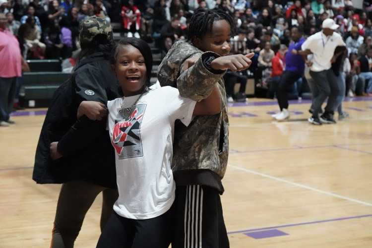 Image shows Minor Middle School students locking arms and smiling while in a crowded school gym.