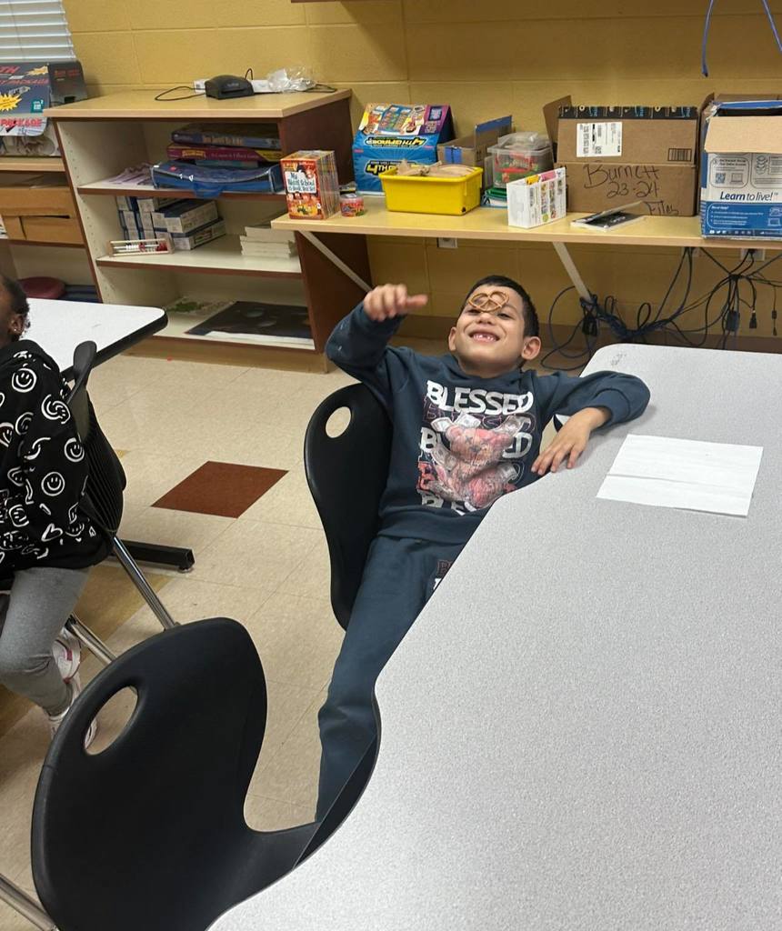 Students balancing a pretzel on their noses