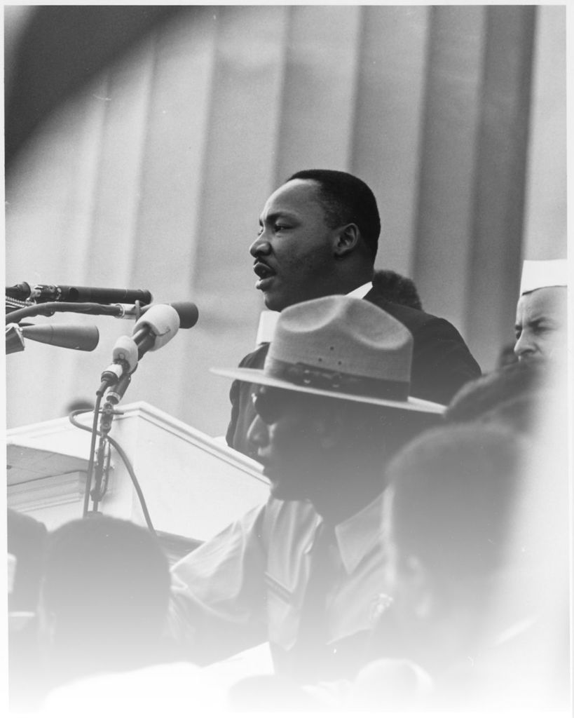 Dr. Martin Luther King Jr. speaks into a microphone