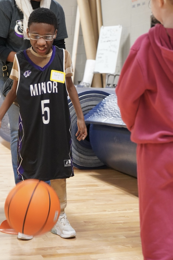 A student tosses a basketball to another student.