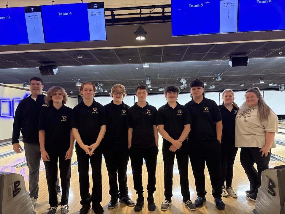 Corner High School's bowling team stands together for a photo at a bowling alley.